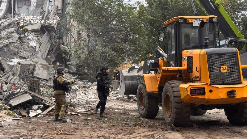Rescuers and machinery at the destroyed residential building, Zaporizhzhia