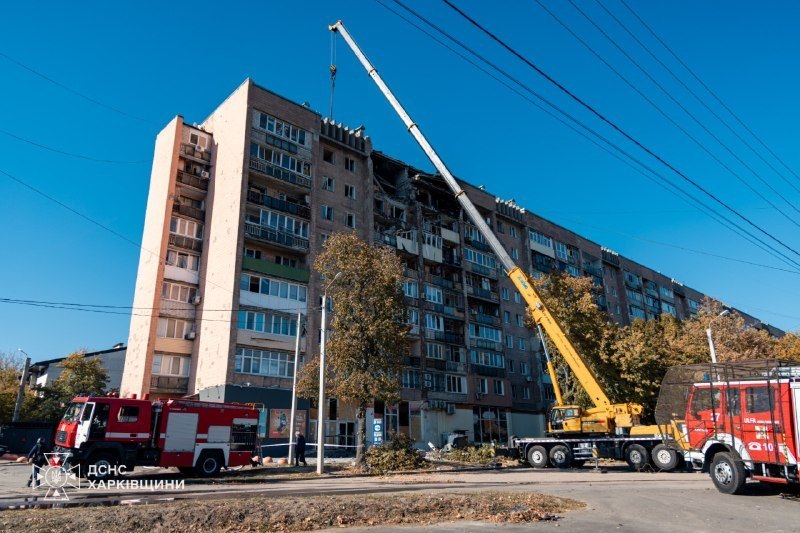 Kharkiv, 12 Oct: a crane and fire engines at the damaged high-rise
