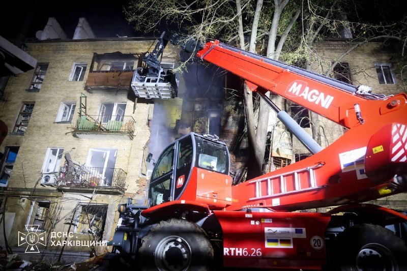 A crane at the damaged building