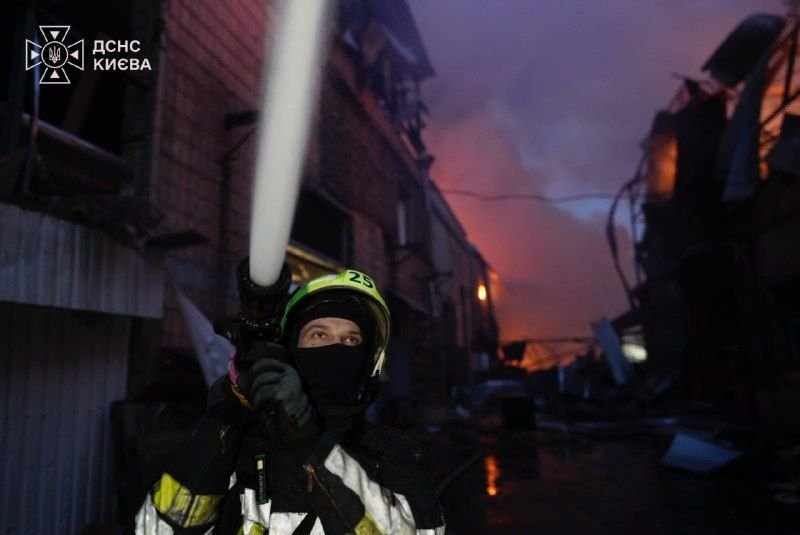 Kyiv, before dawn on 27 Oct: a firefighter at a burning non-residential building after the second wave
