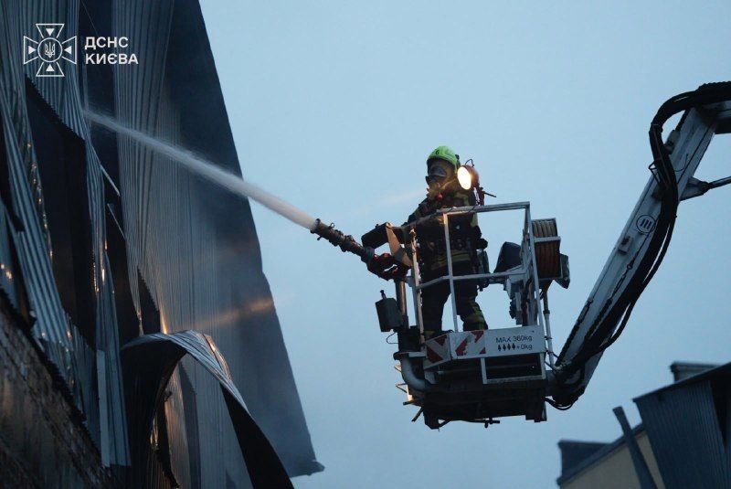 Kyiv, morning of 27 Oct: a firefighter on an aerial platform puts out the fire